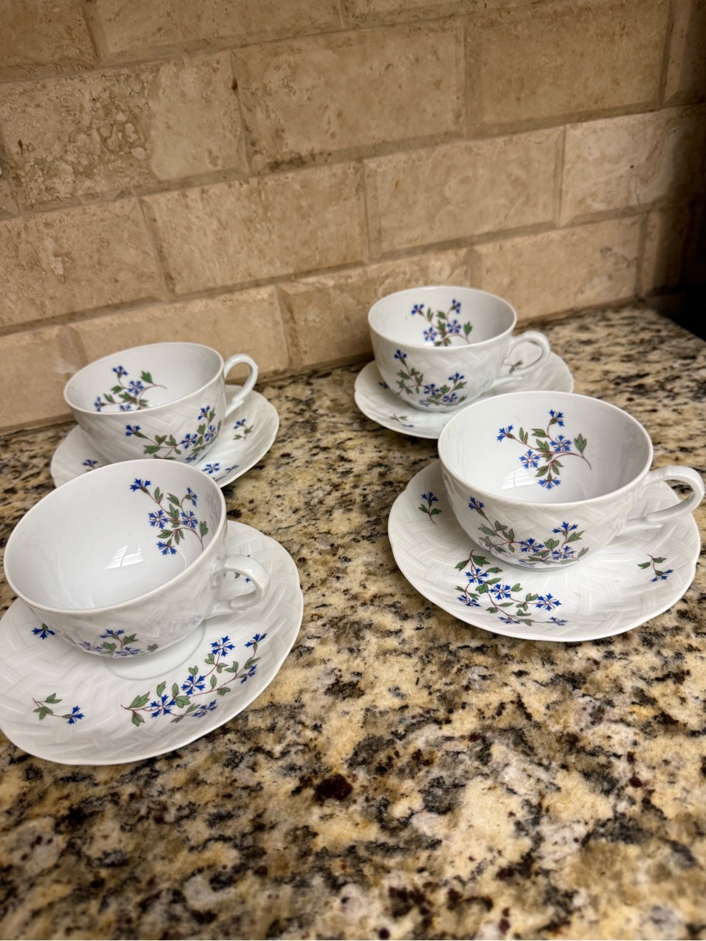 Bernardaud White Porcelain Teacup and Saucer Set with Blue Floral Accents